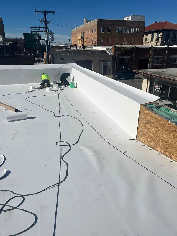 TPO commercial flat roof repair in progress