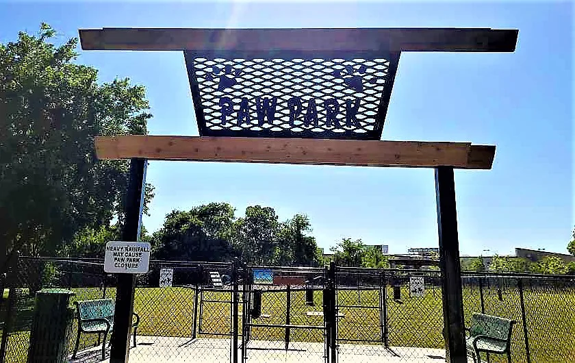 Custom Paw Park metal entrance gate with decorative panel