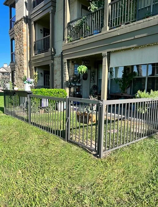 Iron fence and gate around patio enclosure