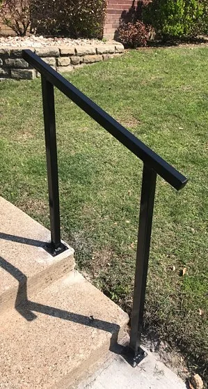 Custom black metal handrail on concrete steps